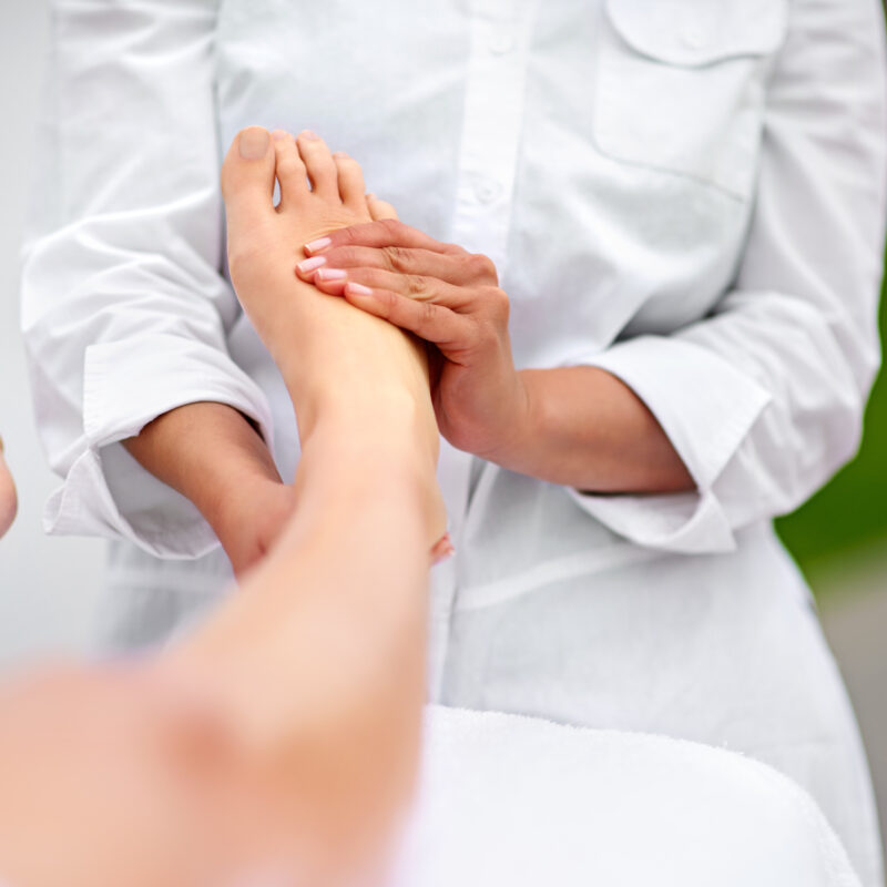 Therapist giving relaxing foot massage session