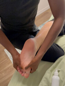 Close-up of deep foot reflexology by Antionette at Salt & Sage Healing
