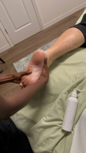 Antionette massaging heel for tension relief at Salt & Sage Healing
