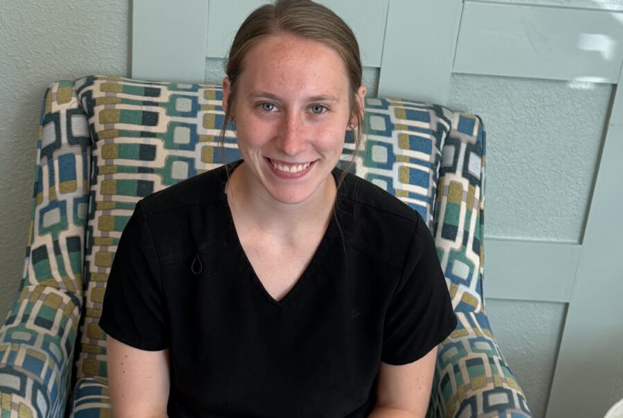 Smiling person sitting on patterned chair