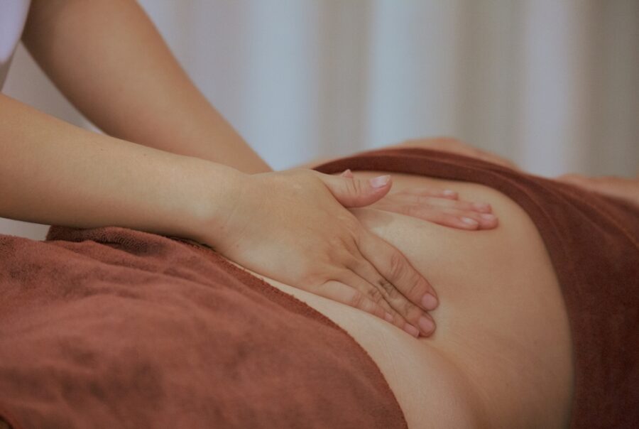 Hands giving a back massage on person.