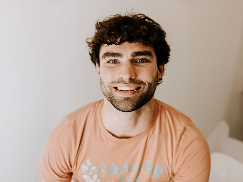 Smiling person in orange t-shirt.