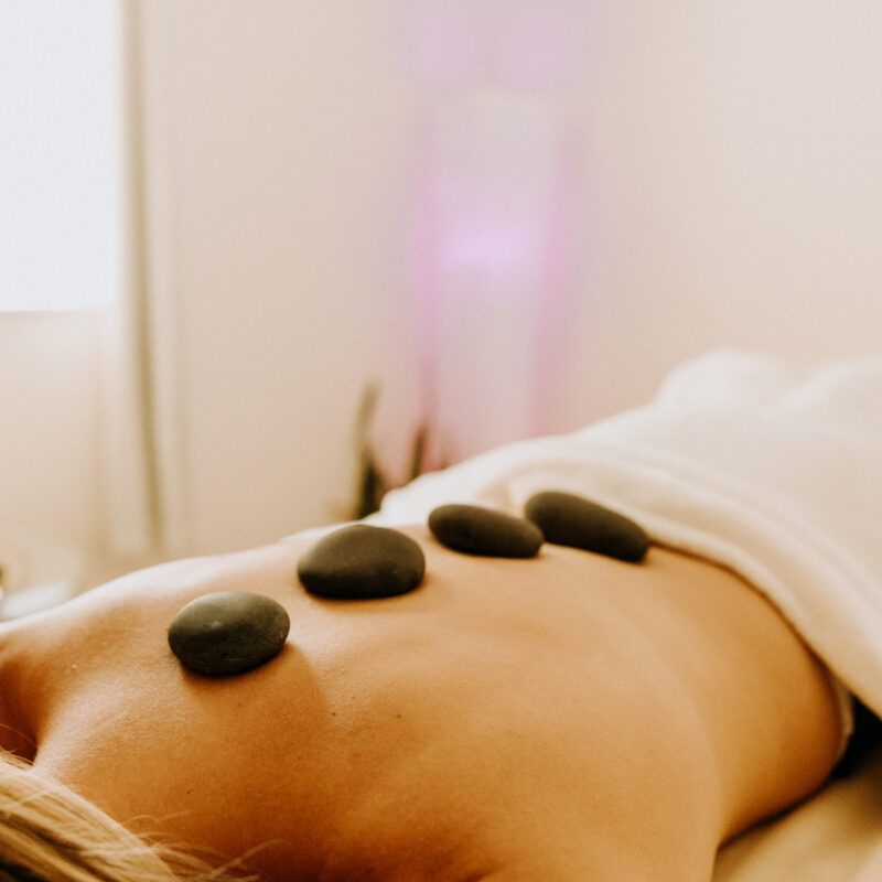 Hot stone therapy on person's back