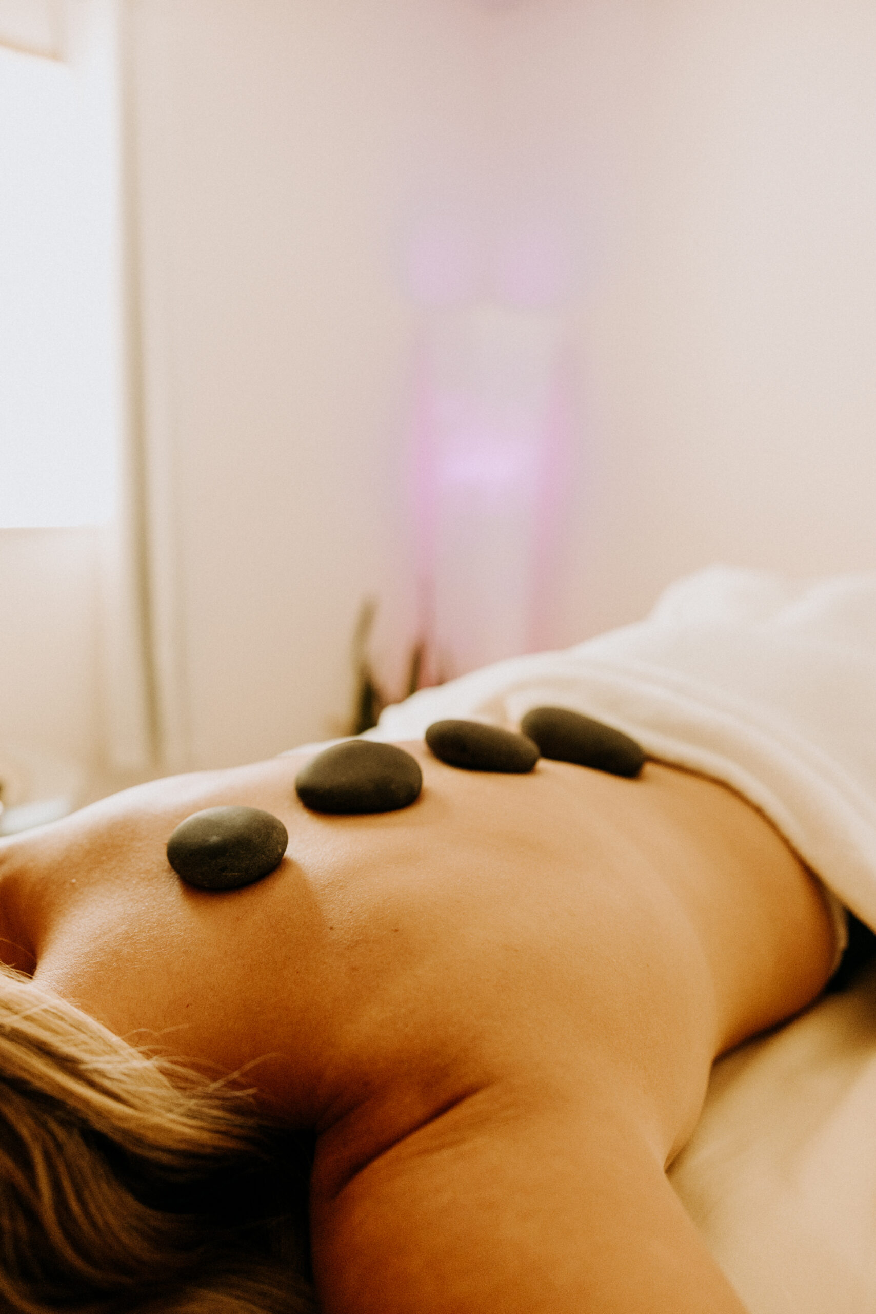 Hot stone therapy on person's back