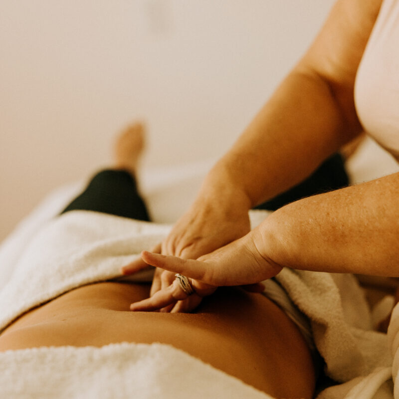 Person receiving a relaxing back massage therapy session.
