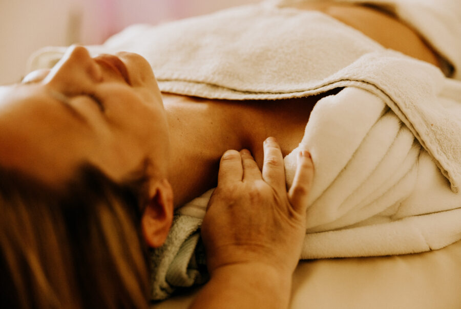 Relaxing massage therapy session on neck and shoulders.