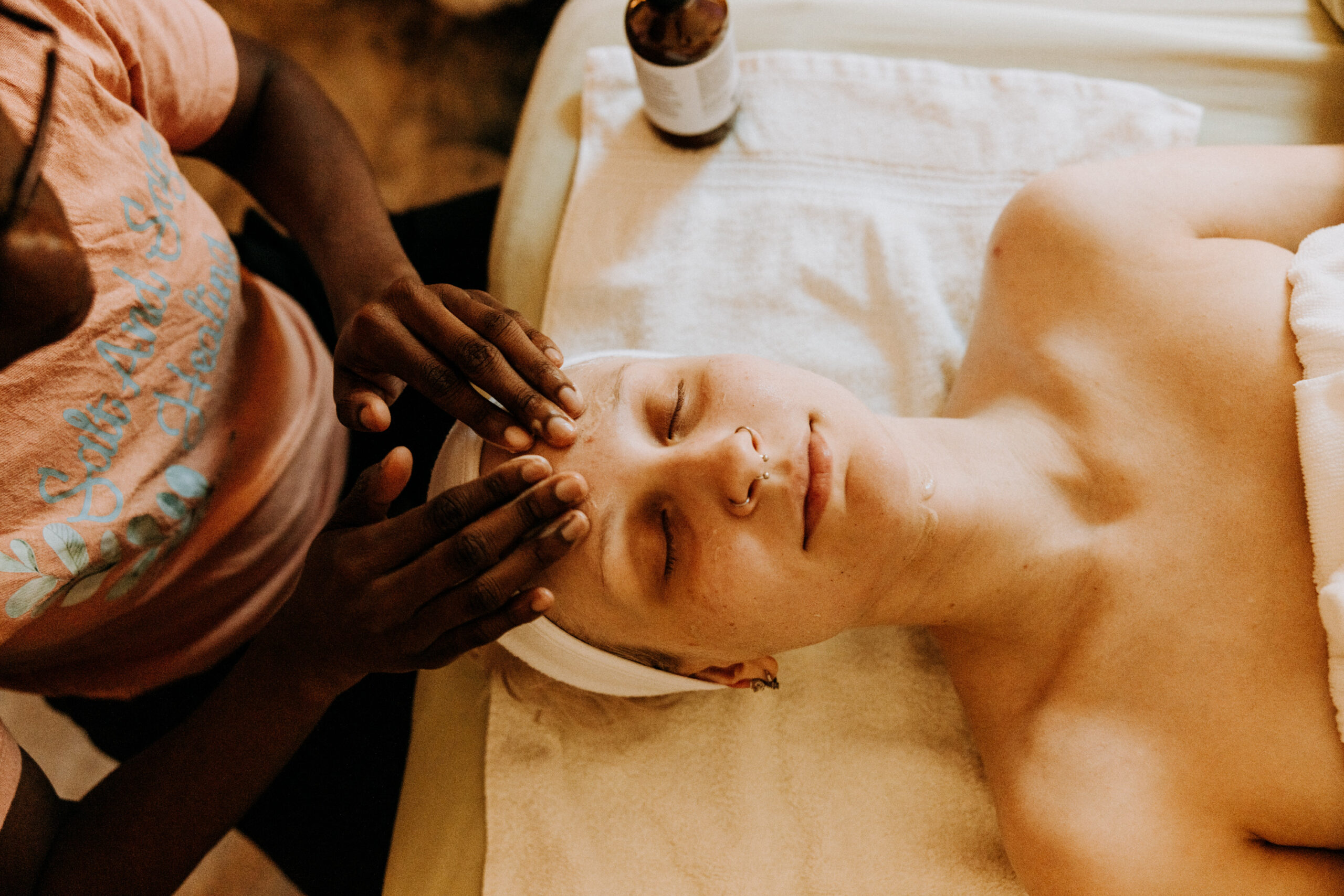Person receiving facial massage at spa