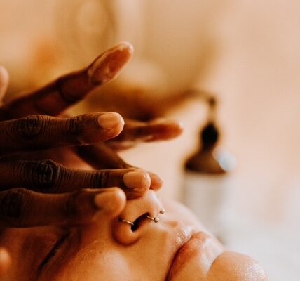 Person receiving calming facial massage therapy session
