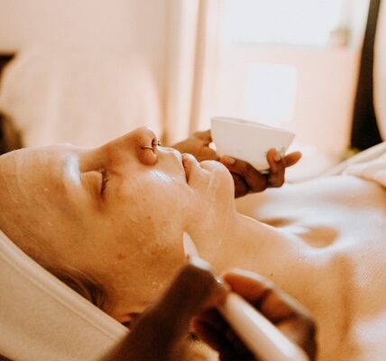 Person receiving a facial treatment at spa.