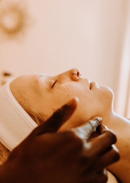 Person receiving relaxing facial treatment in spa