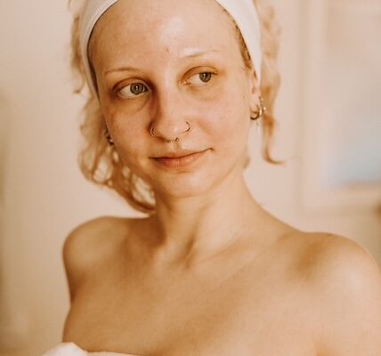 Person with headband and towel, relaxing at home.