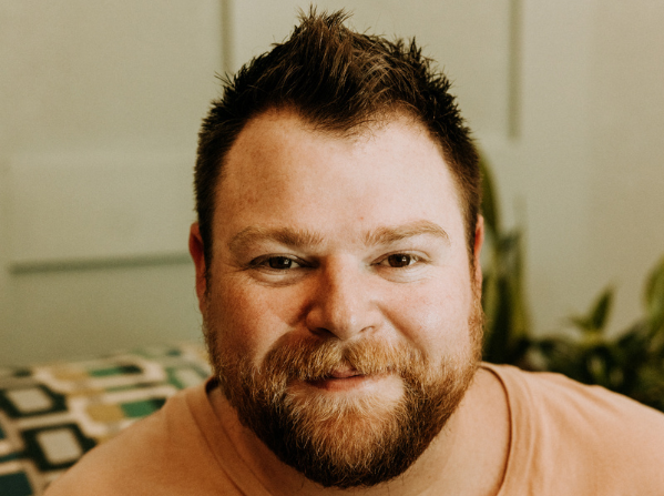 Smiling man with a beard and short hair.